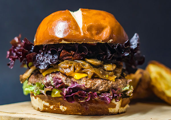 burger loaded with toppings in foodie stag do experience